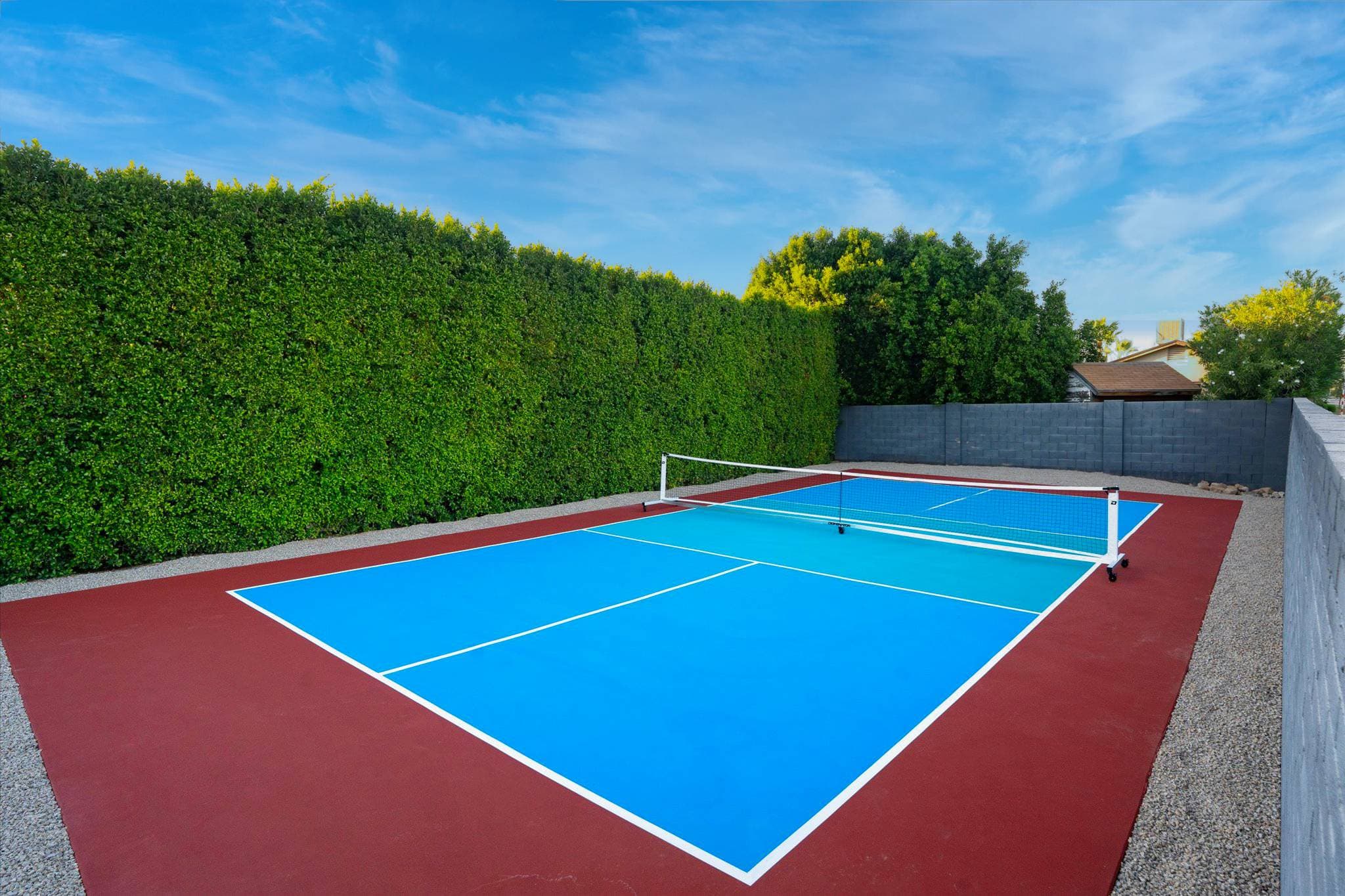 Challenge friends to a match on the brand new - private pickleball court surrounded by tall privacy hedges. With paddles and balls provided, this bright blue court is perfect for outdoor fun and friendly rallies.