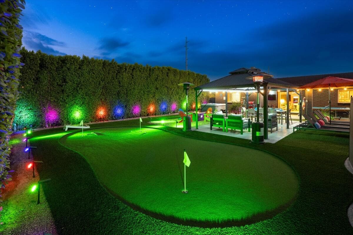 3 hole putting green, gazebo, lounge chairs, patio heaters, fire pit, Polywood chairs, and 14' tall hedges