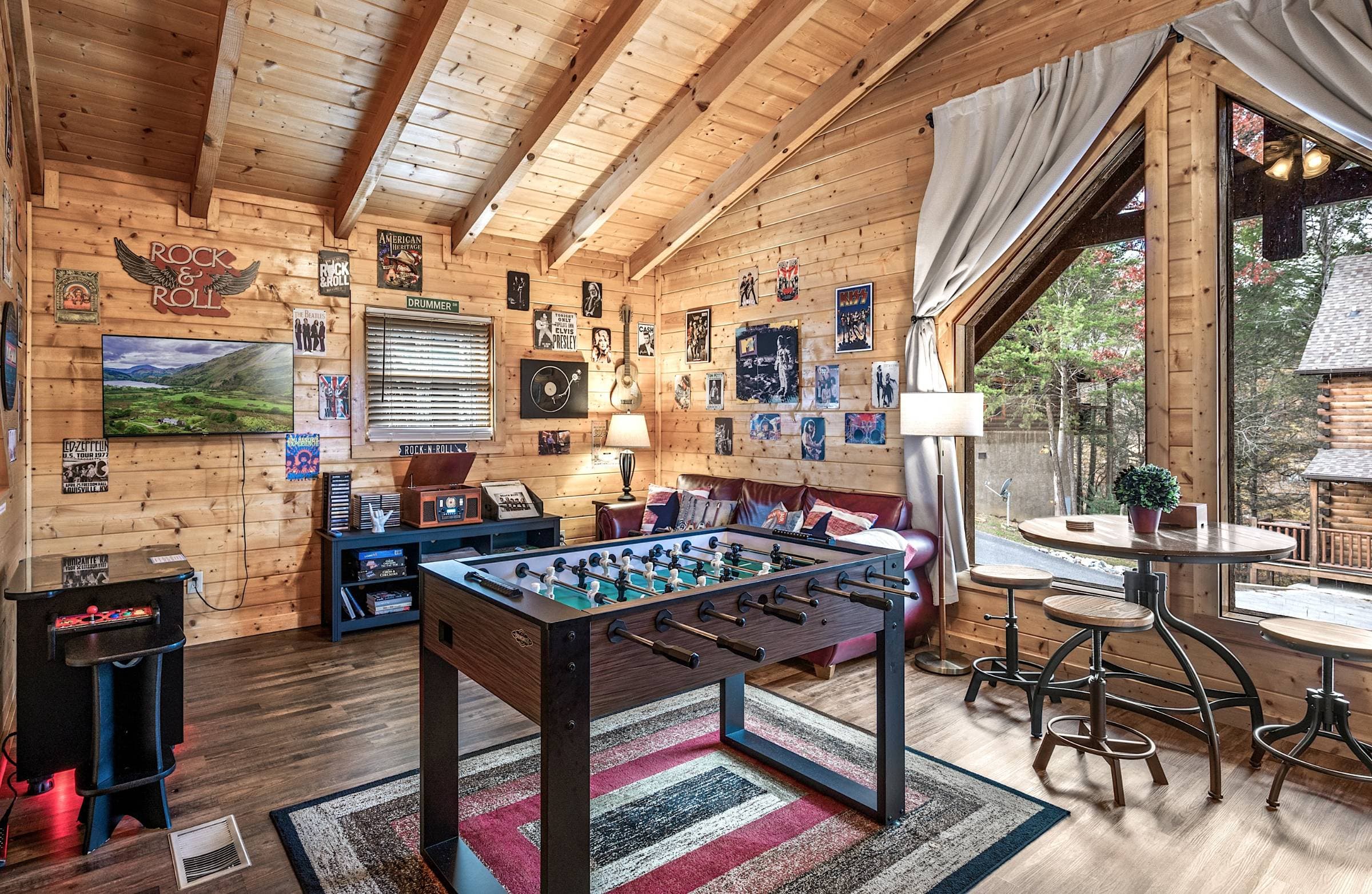 Music-themed loft with a foosball table, multicade arcade game, Victrola music player, CD's, albums, and cassettes, Roku TV, queen bed, pullout queen sleeper sofa, and full bathroom