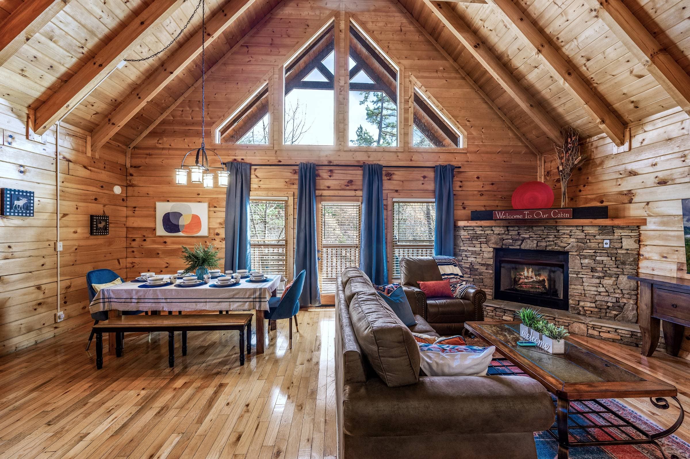 Living room and dining room with a view to the deck and woods 